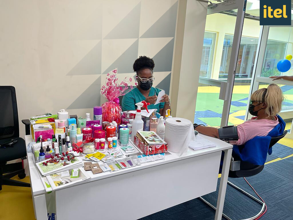 Image of itel employee in Kingston, Jamaica, getting their blood pressure checked during itel's Health and Safety Month, where free on-site health screenings were available. 