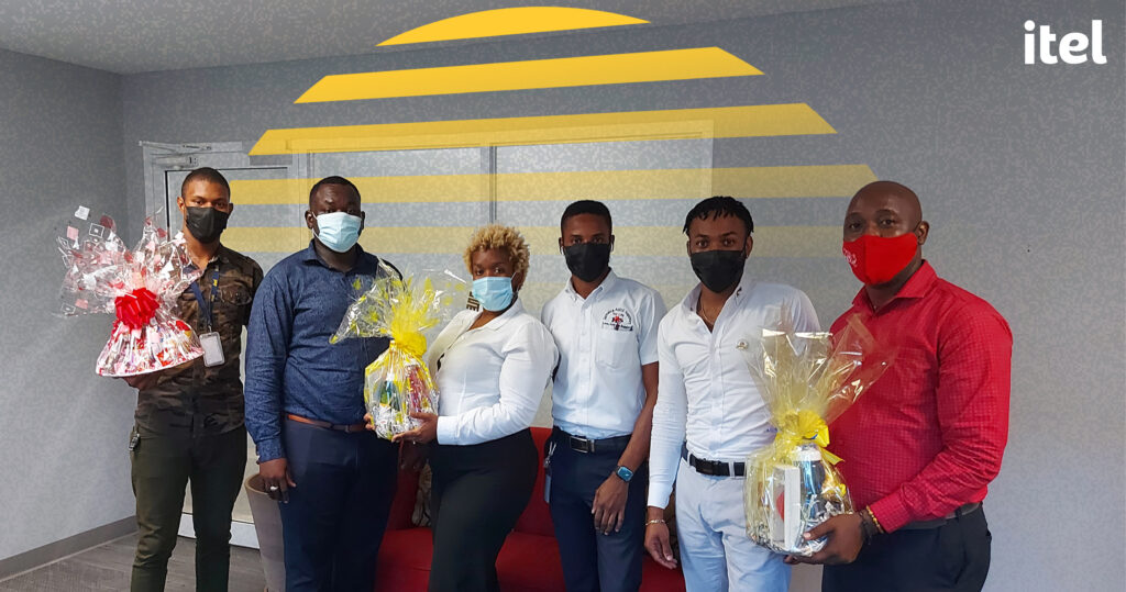 image of itel employees in Montego Bay, Jamaica, receiving raffle prizes for participating in health & wellness related workshops and activities, part of itel's Health and Safety Month in February.