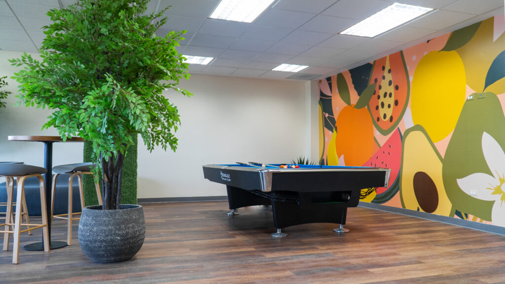 Image of itel's newest Chalmers building, just launched in May 2022, inside their employee chill rooms, which have a fun, Caribbean vibe with colorful murals and decals depicting traditional fruits and vegetables of the region.